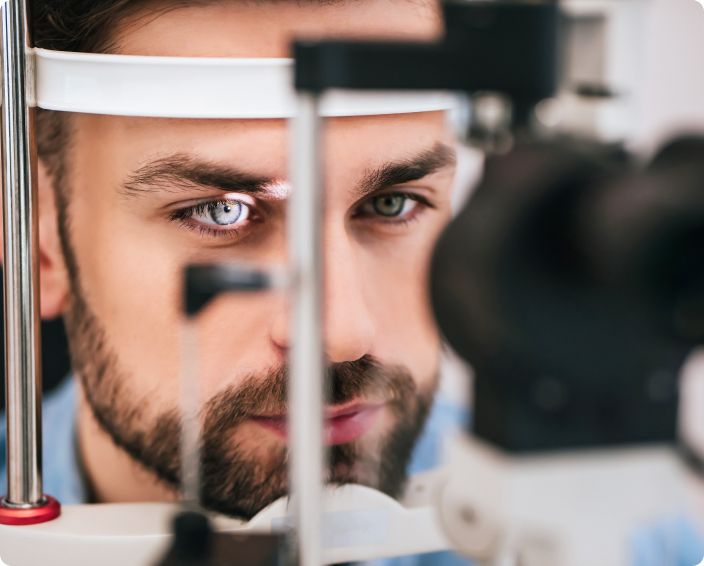 A man's eyes being examined with an ophthalmoscope.