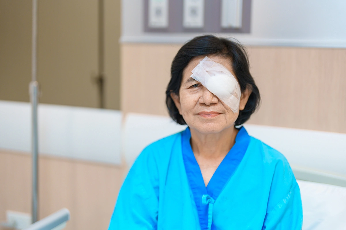 An elderly woman recovering after eye surgery